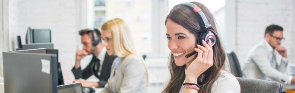 A Female Freight Dispatcher Smiling With a Headset on Her Head