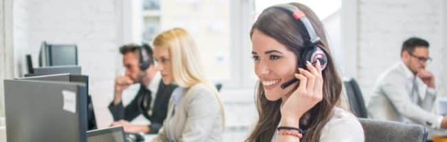 A Female Truck Dispatcher Smiling With a Headset on Her Head