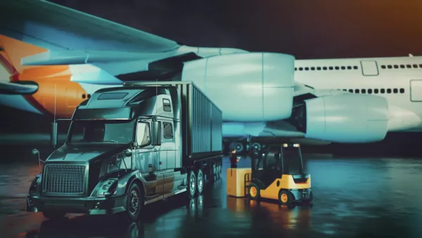 Trucking industry 2023 - a semi truck and trailer parked in front of a plane
