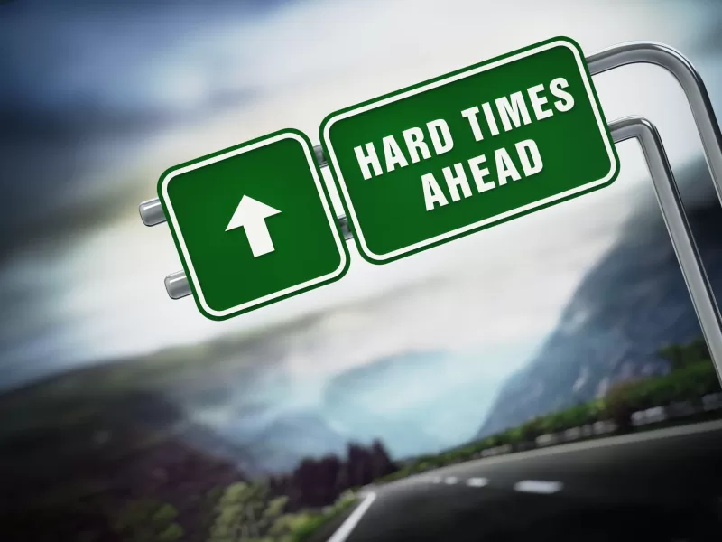 A highway sign that reads "hard times ahead" in reference to trucking industry 2023